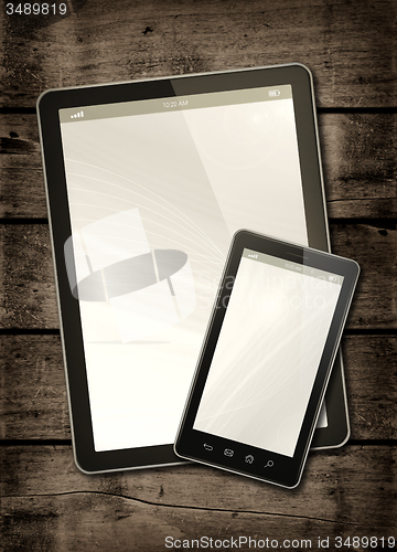 Image of Smartphone and digital tablet PC on a dark wood table
