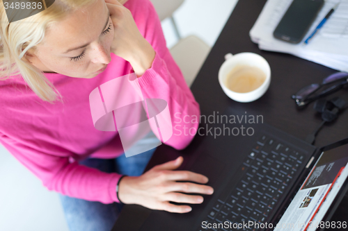 Image of Business woman working from home.