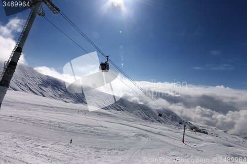 Image of Gondola lift and ski slope at nice sunny day