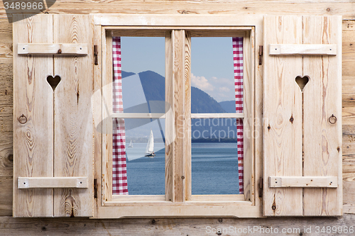 Image of Wooden window with a lake as reflections