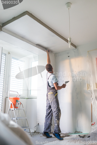 Image of Plasterer renovating indoor walls and ceilings.