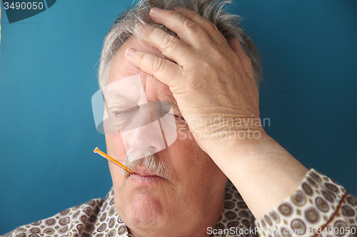 Image of Older man has flu symptoms.