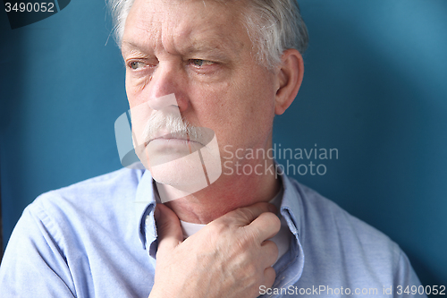 Image of businessman with hand at throat 