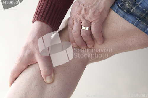 Image of Man checks pain in his leg