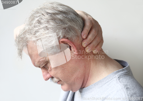 Image of man with headache at base of skull 