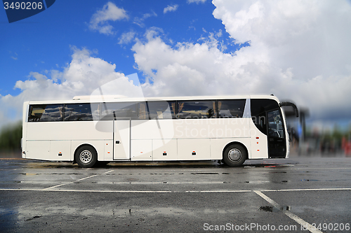 Image of White Coach Bus Waits for Passengers on Foggy Rainy Morning