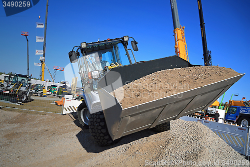 Image of Man Works with Kramer Allrad 350 Wheel Loader