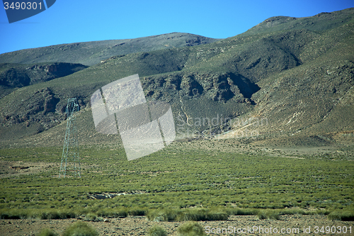 Image of valley in    electrical line high voltage power  isolated hill 