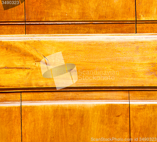 Image of grain texture of a brown antique wooden old door in italy   euro