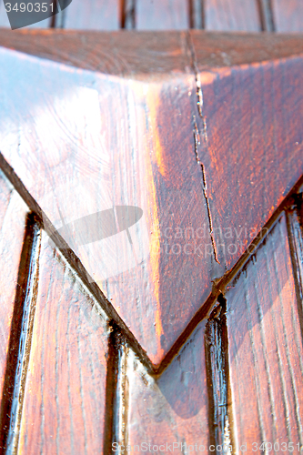 Image of grain   a brown antique wooden old door in italy   
