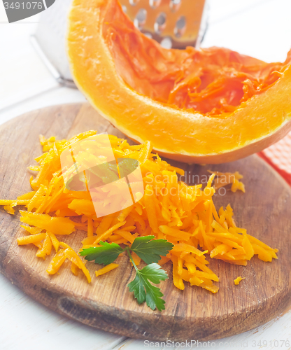 Image of Pumpkin on the wooden board, raw pumpkin