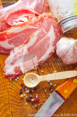 Image of Bacon with aroma spice on the wooden board