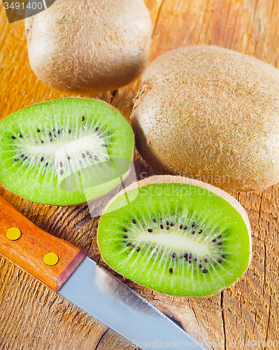 Image of fresh kiwi on the wooden board