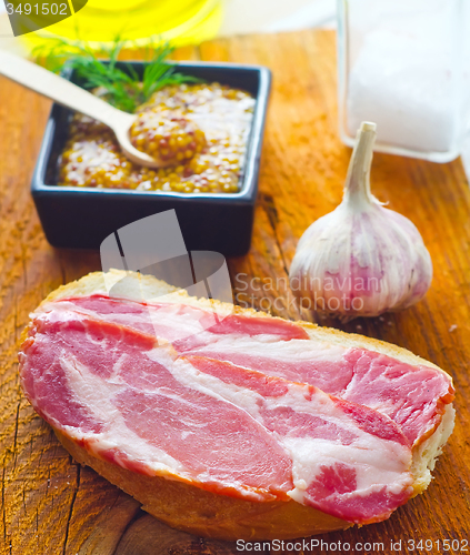 Image of Bread with bacon on the wooden board