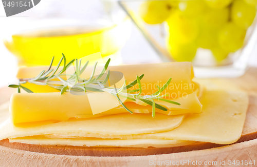 Image of italian cheese with fresh rosemary and grape