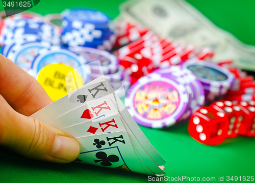 Image of Card for poker in the hand, chips and card for poker