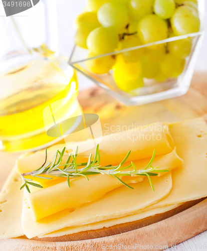 Image of italian cheese with fresh rosemary and grape