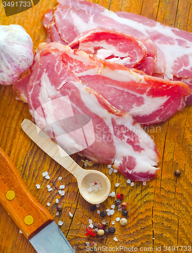 Image of Bacon with aroma spice on the wooden board