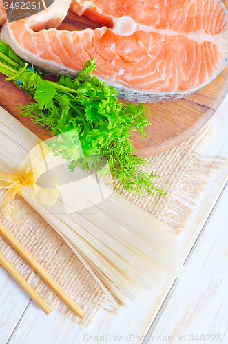 Image of raw rice noodles and raw salmon