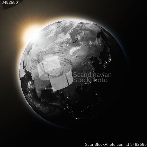 Image of Sun over Southeast Asia on dark planet Earth