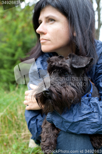 Image of Woman with her dog in nature