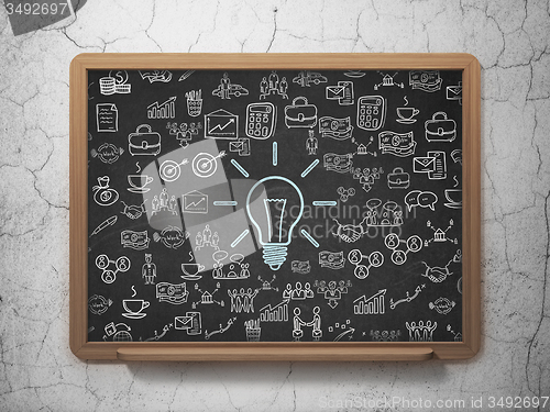 Image of Business concept: Light Bulb on School Board background