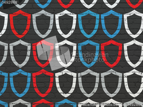 Image of Safety concept: Contoured Shield icons on wall background