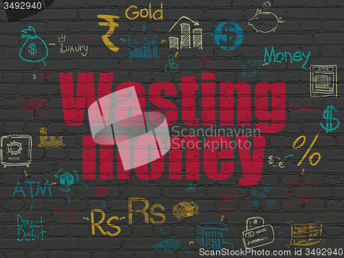 Image of Money concept: Wasting Money on wall background