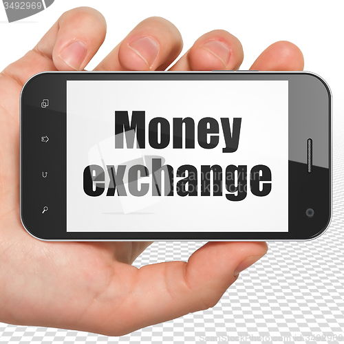 Image of Banking concept: Hand Holding Smartphone with Money Exchange on display