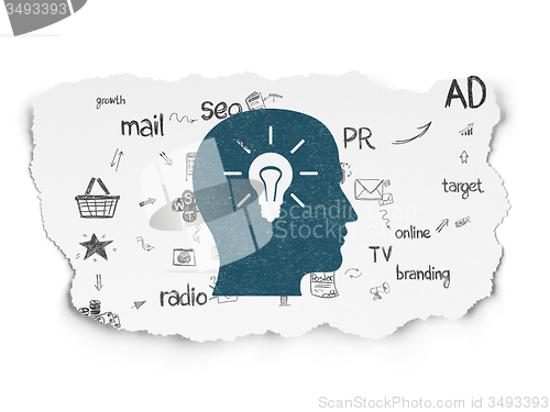 Image of Marketing concept: Head With Light Bulb on Torn Paper background