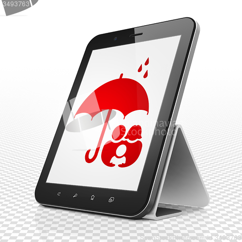 Image of Insurance concept: Tablet Computer with Family And Umbrella on display
