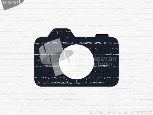 Image of Vacation concept: Photo Camera on wall background