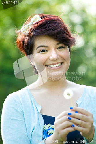 Image of Woman Holding a Dried Dandelion