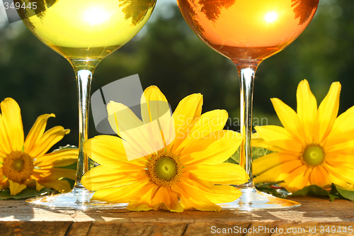 Image of Golden wine in the sun on a rustic table