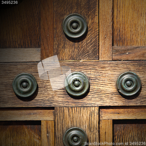 Image of in london antique brown door  rusty  brass nail and light