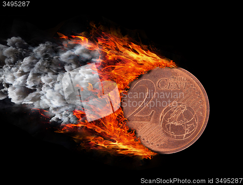 Image of Burning coin with a trail of fire and smoke