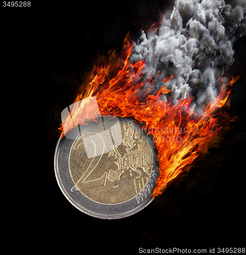 Image of Burning coin with a trail of fire and smoke