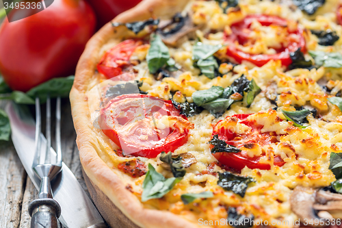 Image of Pizza with cheese and basil close-up.
