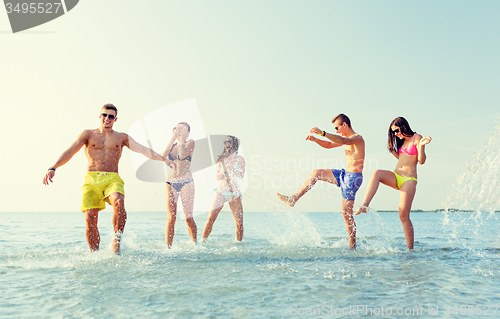 Image of happy friends having fun on summer beach