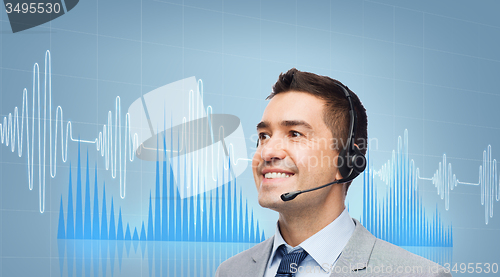 Image of businessman in headset over sound wave or diagram