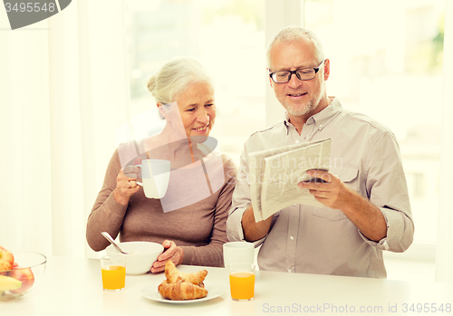 Image of happy senior couple having breakfast at home