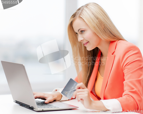 Image of businesswoman with laptop and credit card