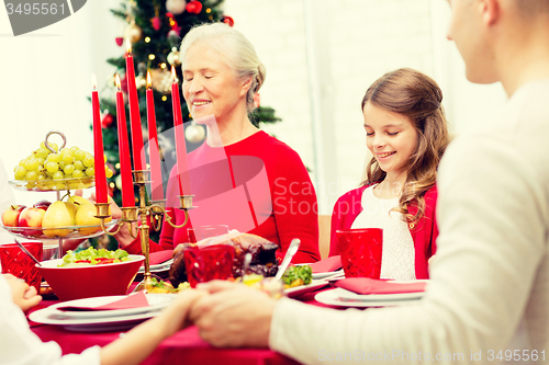 Image of smiling family having holiday dinner at home