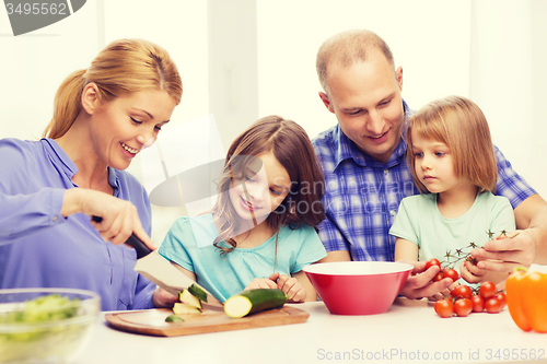 Image of happy family with two kids making dinner at home