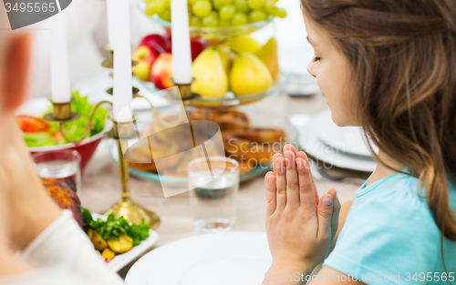 Image of close up of girl praying at holiday dinner