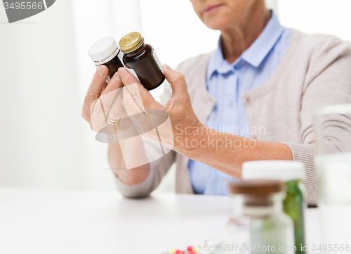 Image of close up of senior woman with medicine jars