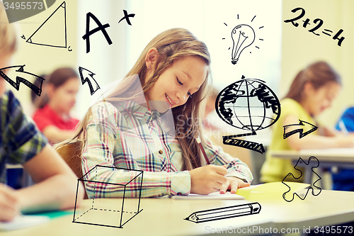 Image of group of school kids writing test in classroom