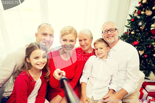 Image of smiling family making selfie at home