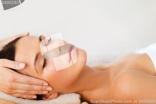 Image of beautiful woman in spa salon having facial