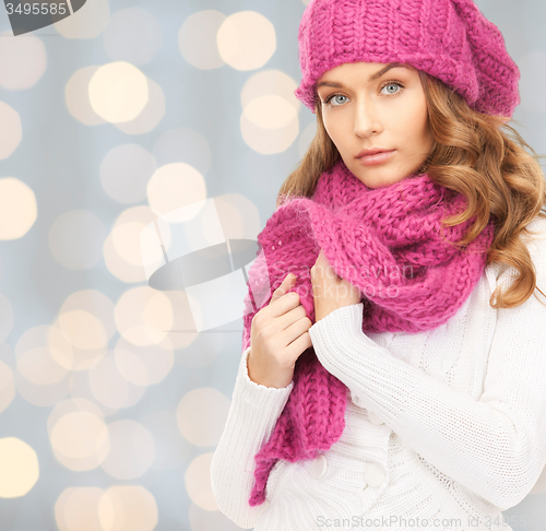 Image of woman in hat and scarf over lights background